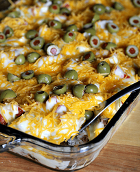 Haystacks-Yummy-casserole-full-of-rice-and-taco-meat-topped-with-a-cheese-sauce-lettuce-tomatoes-and-olives-via-www.julieseatsandtreats.com-.png